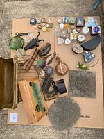 Top-down view showing the entire collection of vintage home décor and trinket items arranged on cardboard.