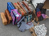 Shows an overview of various luggage pieces laid out outside including brown hard suitcases, colorful soft suitcases, backpacks and smaller patterned bags.