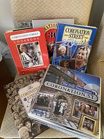 Photo showing six Coronation Street books and DVD trivia game, includes cookbooks and anniversary editions