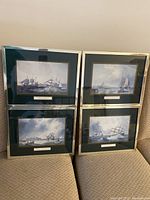Four framed marine paintings by J.W. Carmichael displayed together, showing ships and maritime scenes