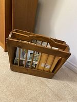 Side angled view showing the pine wooden magazine rack holding maps and envelopes inside.