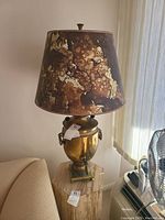 Full view of the brass tone lamp showing the urn-shaped base and brown mottled lampshade.