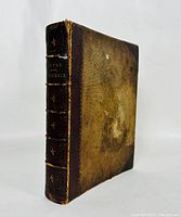 Front and spine view of antique 'Altar of the Household' hardcover book showing brown spine with gold text and decorative details.
