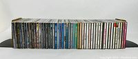 Front view of all CDs lined up side by side showing full collection and album spine designs