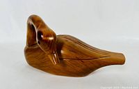 Front side view of the vintage wooden carved Mallard showing smooth carved head and natural wood finish.