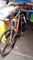 Full view of the CCM Decline mountain bike showing its frame, wheels, and handlebars in a garage setting.