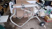 Side view of entire stand showing scissor-leg frame and aluminum guide rails