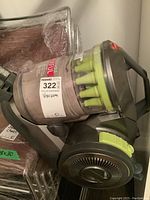 Side view of Hoover Air vacuum canister showing clear dust container and green cyclone tubes inside