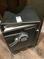 Open safe showing exterior finish, door ajar, and partial interior