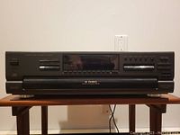 Front view of the Technics SL-PD887 5-disc CD changer player showing power button, several control buttons, LCD display, and the disc changer tray closed.