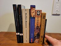 Books standing upright showing spines with titles and authors visible.
