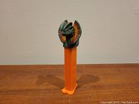 PEZ dispenser with a Dilophosaurus dinosaur head, side view.
