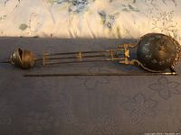 Full length view of pendulum assembly laid flat showing suspension yoke, twin rods, adjustment nut and spherical bob