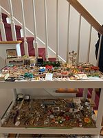 Overview of two-tier table filled with assorted jewelry pieces
