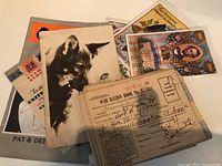 View of World War II ration book along with vintage photograph of a dog and various patriotic cards and stamps