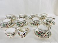 Full set of 9 Aynsley Pembroke cups and matching saucers along with the cream and sugar set.
