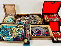 Full view of the jewellery selection laid out in boxes including necklaces, earrings, bracelets, and brooches in various colors and metals.