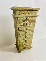 Full frontal photo of the vertical wooden jewellery chest with 8 drawers and top that opens, showing distressed shabby chic green and brown paint.