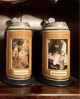 Front view of the two beer steins showing the artwork panels 'Freedom of Worship' and 'Freedom from Fear'.