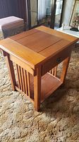 Side angle view showing the slatted panel sides and lower open shelf