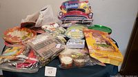 Overview of assorted paper party items including plates, napkins, and Hallmark centerpiece