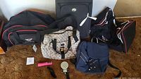 Overview of all travel bags including Ralph Lauren handbag, American Tourister carry-on, Corvette duffle bags, blue backpack, and two luggage scales