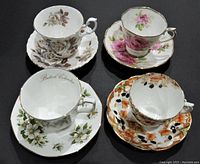 Top view of four tea cup and saucer sets showing different floral designs