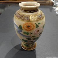 Front angled view of vintage Japanese vase showing colorful floral pattern and upper decorative band