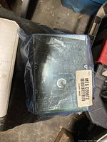 Top view of floppy disk drive showing circuit board side inside anti-static packaging with barcode label.