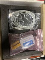 Altera USB Blaster and USB cable coiled and sealed in plastic bags inside foam-padded cardboard box