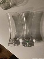 Two crystal vases on white surface showing shape and thickness of bases.