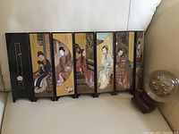 Six-panel decorative folding screen with traditional Asian woman paintings and calligraphy, black frame.