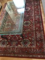 Top angle showing the full length of the carpet under a glass coffee table, highlighting the area pattern and colors