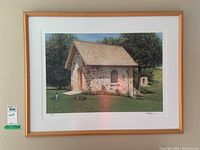 Framed signed limited edition print showing a small stone building with a shingled roof, in a natural setting, signed by Ken Danby.
