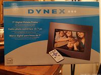 Box front of Dynex 7 inch digital picture frame showing product image and remote control
