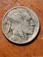 Front obverse side of 1935-D Buffalo Nickel showing Native American profile and date with mint mark.