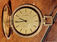 Front open view of Milord pocket watch showing dial with minimalistic hour markers and black hands. Dial marked 'MILORD 17 JEWELS INCABLOC SWISS MADE'.