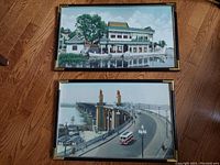 Both vintage embroidered textile artworks shown framed and under glass on wooden floor.