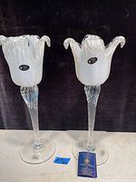 Pair of white crystal Murano Italy candle holders/vases shown standing side by side with blue certificate card identifying them as White Cristal.