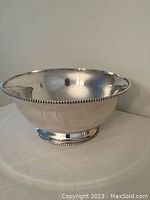 Silver plated bowl with beaded edge around rim and base, polished finish, shown standing alone.