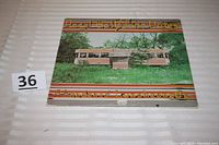 Front cover of the album showing the abandoned diner with the album title and artists' names.