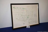 Photo of the entire framed map showing the black wooden frame and map content.