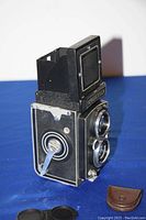 Camera body upright with top viewfinder hood extended, no case attached