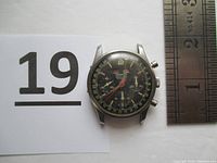 Front view of watch with ruler and reference card, showing dial and case diameter