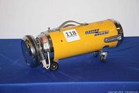 Side view of the yellow cylindrical canister vacuum cleaner showing the 'Electro Hygiene' logo and four wheels.