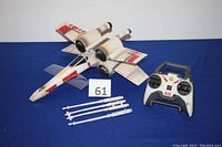 Front view of Air Hogs remote control Star Wars X-Wing toy with remote and removable laser cannons.
