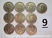 Obverse faces of ten Eisenhower Bicentennial Dollars arranged in rows showing President Eisenhower’s portrait