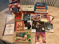 Photo showing an assortment of cookbooks, novels, and children's books arranged on a round table.