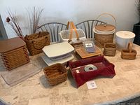 Full display of assorted Longaberger baskets and accessories on table.