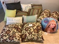Photo showing collection of various throw pillows including floral, striped, solid color, rectangular and special themed pillows.
